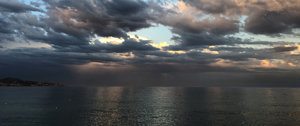 A stormy sky looms over the ocean, filled with dark clouds and rain, symbolizing the challenges of chronic illness.