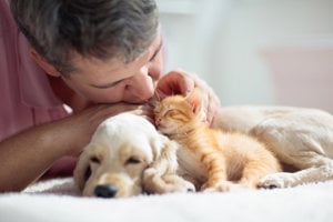 A heartfelt moment as a man kisses his dog, showcasing the emotional support pets provide in combating depression.